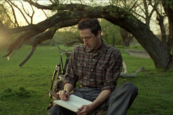 This image released by A24 shows Adrien Brody in a scene from "The Brutalist." (Lol Crawley/A24 via AP)