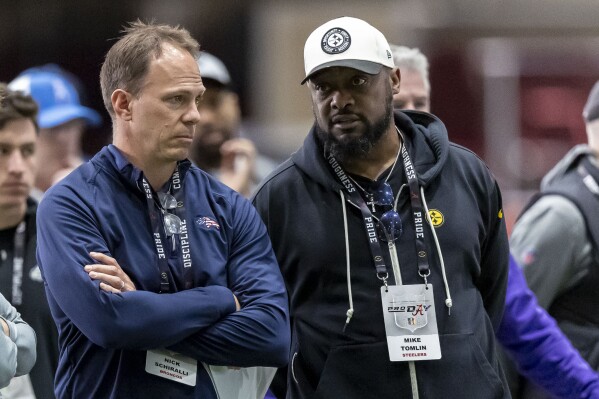 Nick Schiralli, Denver Broncos assistant director of college scouting, left, talks with Pittsburgh Steelers head coach Mike Tomlin as former Alabama players work at Alabama's NFL football pro day, Wednesday, March 20, 2024, in Tuscaloosa, Ala. (AP Photo/Vasha Hunt)