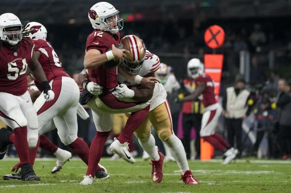 Arizona Cardinals quarterback Colt McCoy is sacked by San Francisco 49ers defensive tackle Kevin Givens during the second half of an NFL football game Monday, Nov. 21, 2022, in Mexico City. (AP Photo/Eduardo Verdugo)