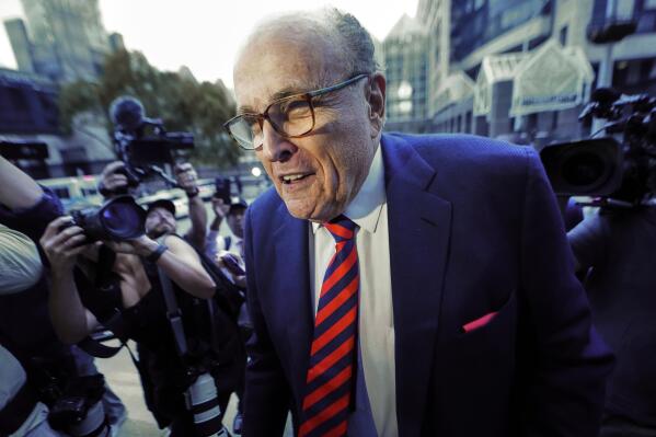FILE - Rudy Giuliani arrives at the Fulton County Courthouse, Aug. 17, 2022, in Atlanta. Daniel Gill, who spent a night in jail for smacking Rudy Giuliani on the back and calling him a "scumbag" last June at a supermarket, is suing Giuliani and several New York City police officers for false arrest and defamation. Gill brought the federal suit in Manhattan court on Wednesday, May 17, 2023, accusing Giuliani of spinning a tale of political violence from an act of harmless heckling. (AP Photo/John Bazemore, File)