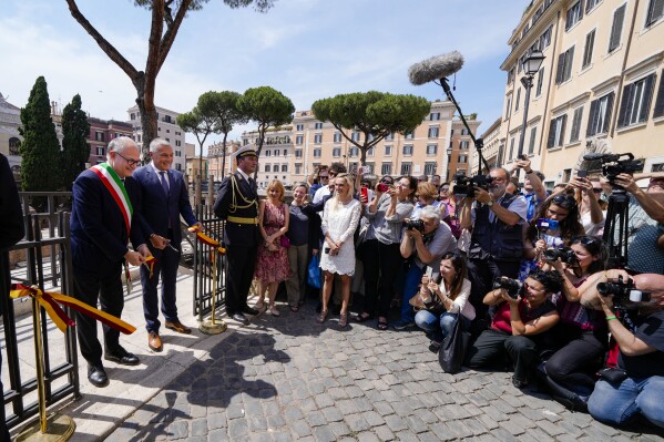 Rome's Mayor Roberto Gualtieri, left, and Bulgari CEO Jean-Christophe Babin cut the ribbon to inaugurate the walkways and nighttime illumination of the so called 'Sacred Area' where four temples, dating back as far as the 3rd century B.C., stand smack in the middle of one of modern Rome's busiest crossroads, Monday, June 19, 2023, With the help of funding from Bulgari, the luxury jeweler, the grouping of temples can now be visited by the public that for decades had to gaze down from the bustling sidewalks rimming Largo Argentina (Argentina Square) to admire the temples below where Julius Caesar masterminded his political strategies and was later fatally stabbed in 44 B.C. (AP Photo/Domenico Stinellis)