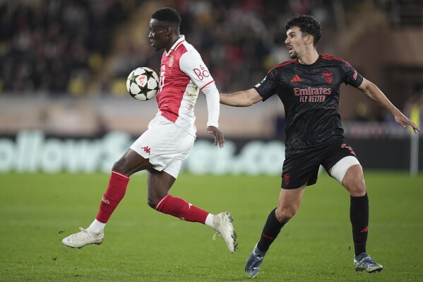 Monaco's Folarin Balogun, left, controls a ball chased by Benfica's Tomas Araujo during a Champions League opening phase soccer match at the Louis II stadium in Monaco, Wednesday, Nov. 27, 2024. (AP Photo/Laurent Cipriani, File)