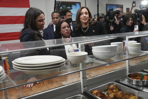 Democratic presidential nominee Vice President Kamala Harris, from right, visits Old San Juan Cafe restaurant with restaurant owner Diana de La Rosa and Rep. Alexandria Ocasio-Cortez, D-N.Y., during a campaign stop in Reading, Pa., Monday, Nov. 4, 2024. (AP Photo/Jacquelyn Martin)