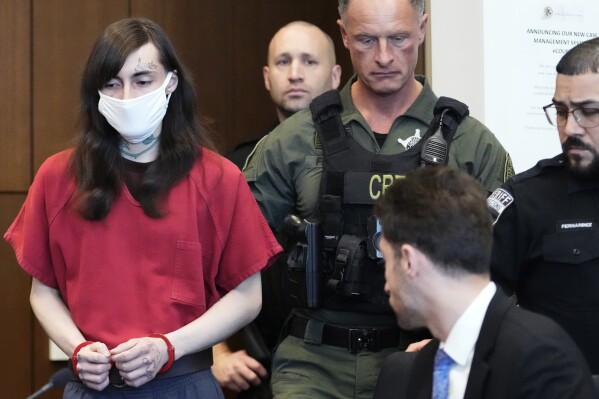 Robert E. Crimo III, left, is escorted into a courtroom during a hearing before Judge Victoria A. Rossetti at the Lake County Courthouse, Waukegan, Ill., Wednesday, Jan. 10, 2024. Crimo is charged in a mass shooting that left seven people dead during a July 4, 2022, parade in Highland Park, Ill. (AP Photo/Nam Y. Huh, Pool)