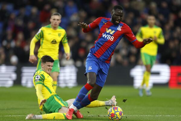 Crystal Palace's Cheikhou Kouyate, right, and Norwich City's Sam Byram battle for the ball during the Premier League match between Crystal Palace and Norwich City at Selhurst Park, London, Tuesday Dec. 28, 2021. (Steven Paston/PA via AP)