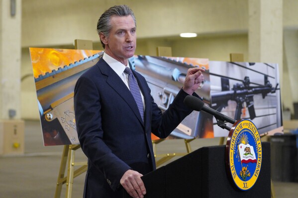 FILE - California Gov. Gavin Newsom speaks to reporters at Del Mar Fairgrounds on Feb. 18, 2022, in Del Mar, Calif. Newsom signed a law, Tuesday, Sept. 26, 2023, raising taxes on gun and ammunition sales to pay for school safety and violence prevention. (Nelvin C. Cepeda/The San Diego Union-Tribune via AP, File)