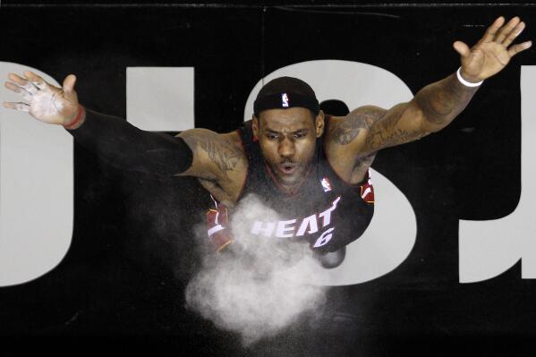 Miami Heat's LeBron James throws powder into the air prior to the team's NBA preseason basketball game against the San Antonio Spurs in San Antonio on Oct. 9, 2010. (AP Photo/Eric Gay, File)