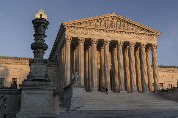 FILE - The Supreme Court is seen at sundown in Washington, on Nov. 6, 2020. The Supreme Court won't allow the Biden administration to implement a policy that prioritizes deportation of people in the country illegally who pose the greatest public safety risk. The court's order on July 21, 2022, leaves the policy frozen nationwide for now. (AP Photo/J. Scott Applewhite, File)