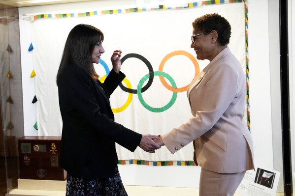 Paris Mayor Anne Hidalgo, left, speaks with Los Angeles Mayor Karen Bass during a meeting at the Paris City Hall Thursday, March 7, 2024. Bass is leading a trip to Paris to prepare for 2028 Olympic Games in Los Angeles. (AP Photo/Christophe Ena)