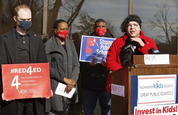 Christine Melendez, president of the Chesterfield Education Association, speaks about the health and safety of students and staff during the COVID-19 Omicron surge during a news conference outside the Richmond Education Assoc. office in Richmond, Va., Monday, Jan. 24, 2022. (Alexa Welch Edlund/Richmond Times-Dispatch via AP)