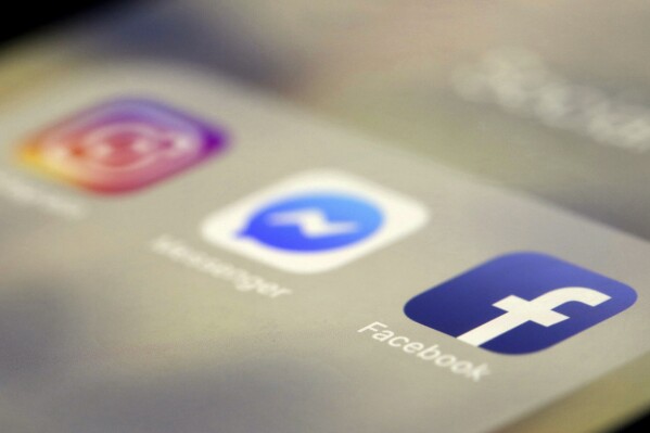 FILE - Social media applications are displayed on an iPhone, March 13, 2019, in New York. An independent Russian news site has reported that a court in Russia convicted the spokesman of U.S. technology company Meta, which owns Facebook and Instagram, of justifying terrorism and sentenced him to six years in prison in absentia. (Ǻ Photo/Jenny Kane, File)