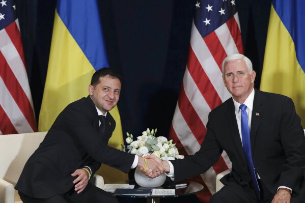Ukraine's President Volodymyr Zelenskiy, left, shakes hands with U.S. Vice President Mike Pence, in Warsaw, Poland, Sunday, Sept. 1, 2019. (AP Photo/Petr David Josek)