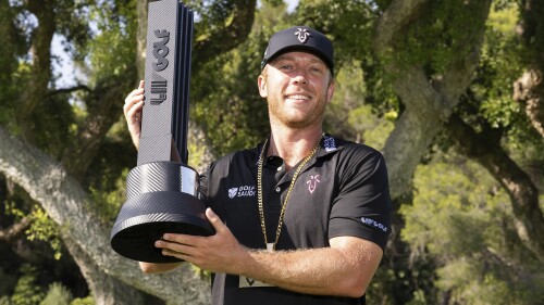 First-place individual champion Talor Gooch, of RangeGoats GC, poses with the trophy after the final round of LIV Golf Andalucía at Real Club Valderrama, Sunday, July 2, 2023, in San Roque, Spain. (Montana Pritchard/LIV Golf via AP)