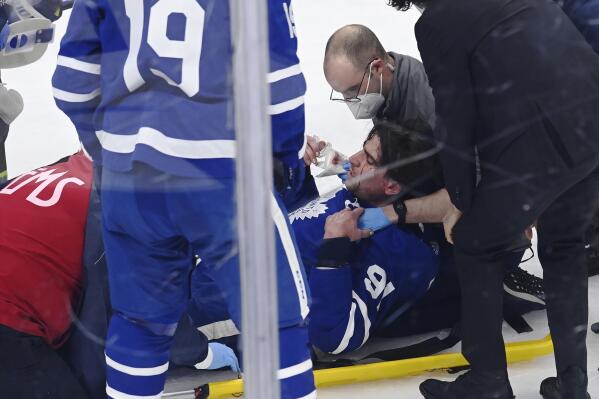 Toronto Maple Leafs forward John Tavares (91) is helped onto a stretcher after being injured during the first period of Game 1 against the Montreal Canadiens in an NHL hockey Stanley Cup first-round playoff series Thursday, May 20, 2021, in Toronto. (Frank Gunn/The Canadian Press via AP)