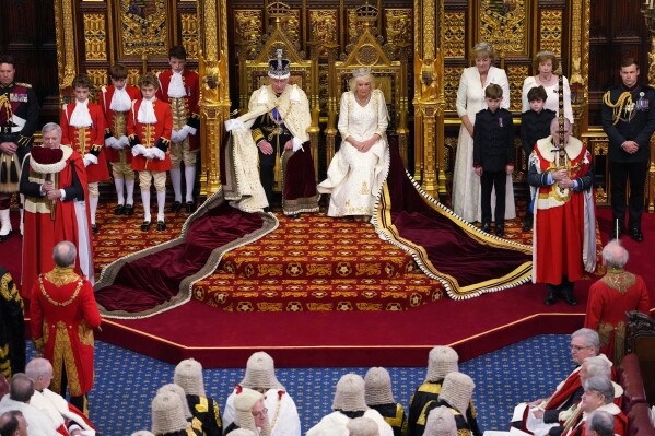 FILE - Britain's King Charles III sits besides Queen Camilla during the State Opening of Parliament at the Palace of Westminster in London on Nov. 7, 2023. The king's cancer diagnosis heaps more pressure on the British monarchy, which is still evolving after the 70-year reign of the late Queen Elizabeth II. When he succeeded his mother 18 months ago, Charles' task was to demonstrate that the 1,000-year-old institution remains relevant in a modern nation whose citizens come from all corners of the globe. Now the king, who turned 75 in November, will have to lead that effort while undergoing treatment for cancer. (AP Photo/Kirsty Wigglesworth, Pool, File)