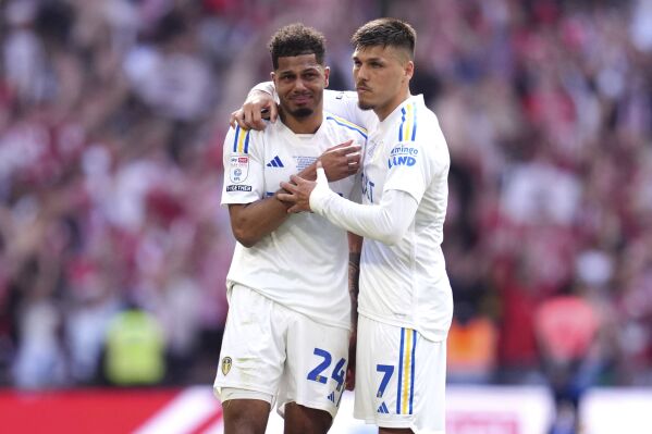 Leeds United's Georginio Rutter, left, and Joel Piroe after being defeated by Southampton in the Championship play-off final at Wembley Stadium, London, Sunday May 26, 2024. (Adam Davy/PA via AP)