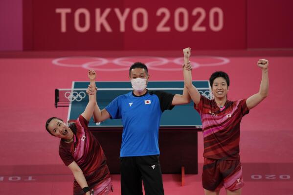 Japan's Mima Ito, left, and Jun Mizutani celebrate after winning the table tennis mixed doubles gold medal match against China's Xu Xin and Liu Shiwen at the 2020 Summer Olympics, Monday, July 26, 2021, in Tokyo. (AP Photo/Kin Cheung)