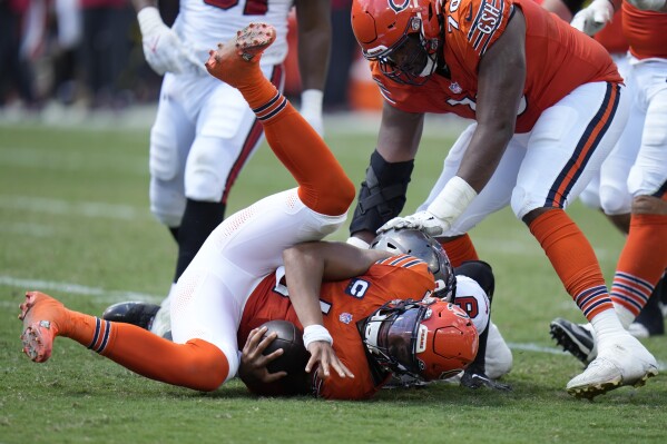 Chicago Bears quarterback Justin Fields (1) is sacked by Tampa Bay Buccaneers linebacker Joe Tryon-Shoyinka (9) during the second half of an NFL football game, Sunday, Sept. 17, 2023, in Tampa, Fla. (AP Photo/Chris O'Meara)