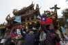 Supporters of Taiwan People's Party (TPP) presidential candidate Ko Wen-je await his arrival at a temple in New Taipei City, Taiwan, Wednesday, Jan. 10, 2024.  Taiwan will hold elections for president and 113-member legislature on Saturday under heavy pressure from China, making the outcome important for the Asia-Pacific region as well as the US (AP Photo/Ng Han Guan)