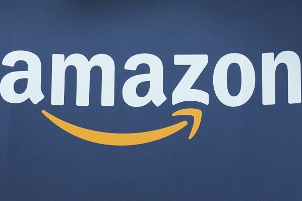 FILE - The Amazon logo is seen, June 15, 2023, at the Vivatech show in Paris. Amazon is moving from putting plastic air pillows in its packages to using recycled paper filling instead, a move that's more environmentally friendly and secures items in boxes better. The company said Thursday, June 20, 2024 that it's already replaced 95% of the plastic air fillers with paper filler in North America and is working toward complete removal by year's end. (AP Photo/Michel Euler, File)