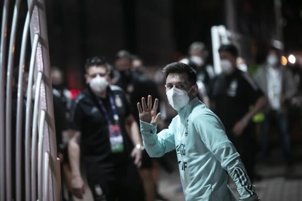 Argentina's Lionel Messi waves to fans as he arrives at a hotel after training for Saturday's Copa America championship soccer match against Brazil, in Rio de Janeiro, Brazil, Friday, July 9, 2021. (AP Photo/Bruna Prado)