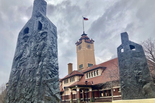 FILE - Sculptures representing charred chimneys rising from the smoldering rubble of burned-out buildings make up the Centennial memorial of the 1908 Race Riot entitled, "Acts of Intolerance" by Preston Jackson, on Wednesday March 22, 2023, in Springfield, Ill. (AP Photo/John O'Connor, File)