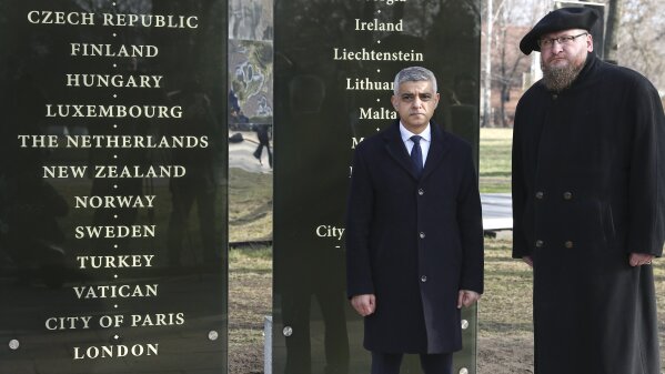 Mayor of London Sadiq Khan, left, and the director of the Auschwitz-Birkenau State Museum Piotr Cywinski attend commemorations marking the 75th anniversary of the Soviet army's liberation of the Auschwitz Nazi death camp in Oswiecim, Poland, Monday, Jan. 27, 2020. London Mayor Sadiq Khan pledged 300,000 pounds ($390,000) to the Auschwitz-Birkenau Foundation, arguing that the institution plays a vital role in educating Londoners visiting the site on the horrors of the Holocaust. (AP Photo/Czarek Sokolowski)
