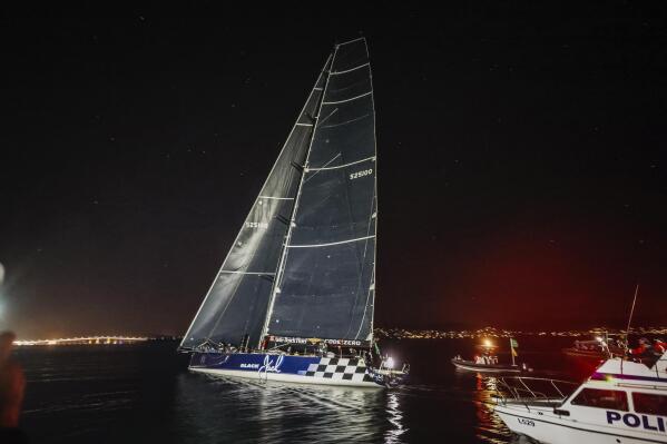 In this photo provided by RSHYR/Salty Dingo the Monaco Yacht Club-based Black Jack crosses the finish line in the Sydney Hobart yacht race early in the morning on Wednesday, Dec. 29, 2021, in Hobart, Australia. This year's 628-nautical mile event (about 720 miles; 1,170 kilometers) has been one of the slower races in recent memory. (Salty Dingo/RSHYR via AP)