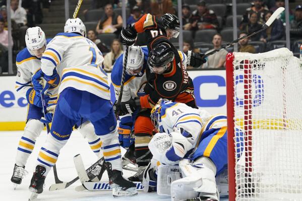 Anaheim Ducks' Adam Henrique, center right, fights for the puck with Buffalo Sabres' John Hayden in front of Sabres goaltender Craig Anderson during the second period of an NHL hockey game Thursday, Oct. 28, 2021, in Anaheim, Calif. (AP Photo/Jae C. Hong)