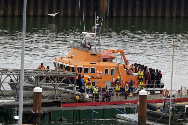 A group of people thought to be migrants are brought in to Dover, Kent, by the Border Force following a small boat incident in the Channel, on Tuesday April 23, 2024. British Prime Minister Rishi Sunak said "nothing will stand in our way" of getting flights to Rwanda off the ground, as the Government braced itself for legal challenges to the scheme to send asylum seekers to the east African country. (Gareth Fuller/PA via AP)