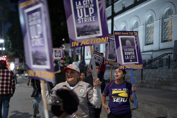 Los Angeles city employees with SEIU Local 721 picket outside of City Hall in Los Angeles on Tuesday, Aug. 8, 2023. Thousands of Los Angeles city employees, including sanitation workers, engineers and traffic officers, walked off the job for a 24-hour strike alleging unfair labor practices. The union said its members voted to authorize the walkout because the city has failed to bargain in good faith and also engaged in labor practices that restricted employee and union rights. (David Crane/The Orange County Register via AP)