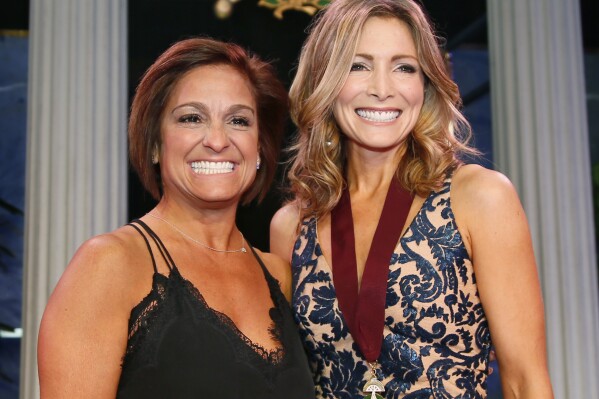 FILE - Oklahoma Hall of Fame inductee Shannon Miller, right, stands with her presenter, Mary Lou Retton, in Oklahoma City on Nov. 16, 2017. Retton. 55, is in intensive care in a Texas hospital fighting a rare form of pneumonia, according to her daughter McKenna Kelley. (AP Photo/Sue Ogrocki, File)