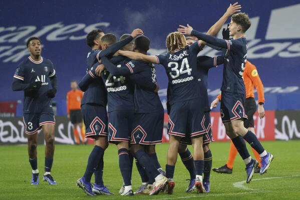 PSG players celebrate after PSG's Thilo Kehrer, third from left, scored his side's opening goal during the French League One soccer match between Lyon and Paris Saint-Germain in Lyon, France, Sunday, Jan. 9, 2022. (AP Photo/Laurent Cipriani)