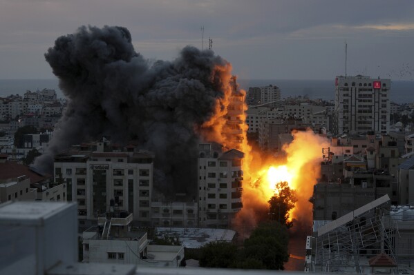 A ball of fire and smoke rise from an explosion on a Palestinian apartment tower following an Israeli air strike in Gaza City, Saturday, Oct. 7, 2023. (AP Photo/Adel Hana)
