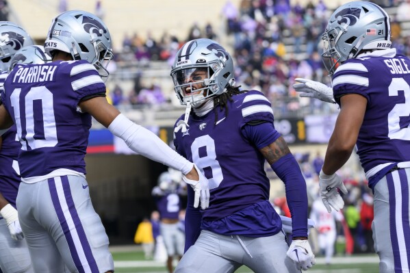 Kansas State cornerback Will Lee III (8) celebrates his interception against Houston with cornerback Jacob Parrish (10) and safety Marques Sigle (21) during the second half of an NCAA college football game in Manhattan, Kan., Saturday, Oct. 28, 2023. (AP Photo/Reed Hoffmann)