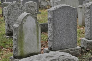 FILE - This Dec. 11, 2019 file photo shows gravestones at a cemetery in New Jersey. The U.S. suicide death rate fell slightly in 2019, the first annual decline in more than a decade, according to new government data. (AP Photo/Seth Wenig)