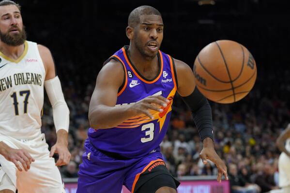 Phoenix Suns guard Chris Paul (3) chases down a rebound as New Orleans Pelicans center Jonas Valanciunas (17) looks on during the first half of an NBA basketball game, Friday, Oct. 28, 2022, in Phoenix. (AP Photo/Matt York)