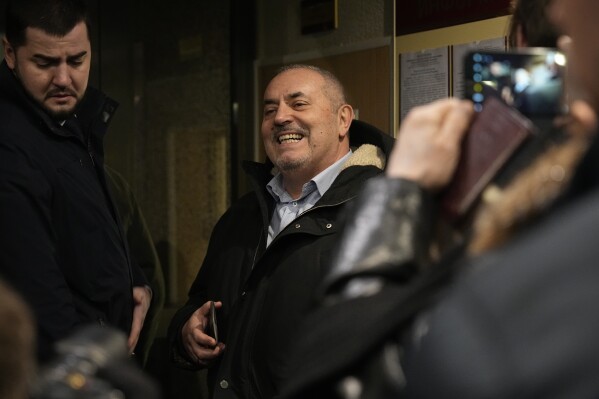 Boris Nadezhdin, a liberal Russian politician who is seeking to run in the March 17 presidential election, center, enters the Russia's Supreme Court for a hearing which is considering his complaint against the signature collection procedure, in Moscow, Russia, Thursday, Feb. 15, 2024. (AP Photo/Alexander Zemlianichenko)