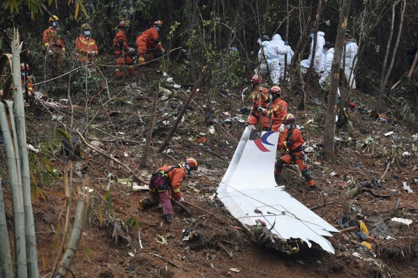 FILE - In this photo released by Xinhua News Agency, search and rescue workers search through debris at the China Eastern flight crash site in Tengxian County in southern China's Guangxi Zhuang Autonomous Region on March 24, 2022. Two years after a Boeing 737-800 passenger jet crashed on a domestic flight in China, killing all 132 people on board, accident investigators indicated Wednesday, March 20, 2024 that they have not yet determined the cause. (Lu Boan/Xinhua via AP, File)