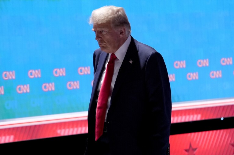 Republican presidential candidate former President Donald Trump walks off stage during the break of a presidential debate with President Joe Biden, Thursday, June 27, 2024, in Atlanta. (AP Photo/Gerald Herbert)