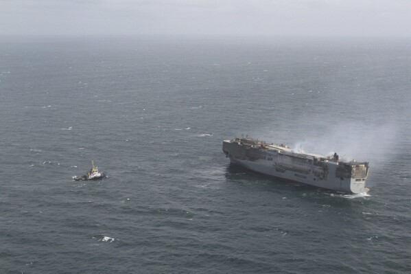 The freight ship, the Fremantle Highway, in the North Sea, Sunday July 30, 2023. Salvage crews began towing a burning cargo ship loaded with thousands of new cars to a temporary anchorage off the northern Dutch coast on Sunday after smoke from the stricken vessel eased, authorities said. (Kustwacht Nederland/Coast Guard Netherlands via AP)