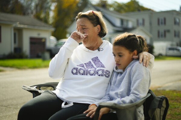 Tammy Asselin, who was at the Schemengees Bar and Grille with her daughter, Toni, during the recent mass shooting, wipes her face during an interview in Lewiston, Maine, Friday, Oct. 27, 2023. (AP Photo/Matt Rourke)