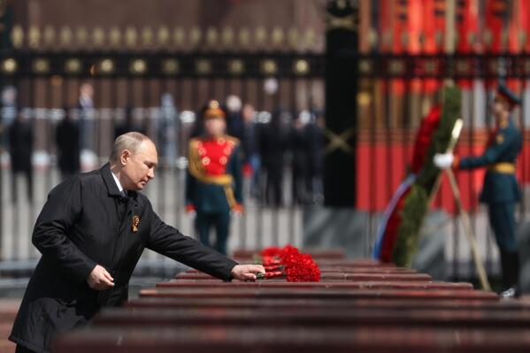 Russian President Vladimir Putin attends a wreath-laying ceremony at the Tomb of the Unknown Soldier after the military parade marking the 77th anniversary of the end of World War II in Moscow, Russia, Monday, May 9, 2022. (Anton Novoderezhkin, Sputnik, Kremlin Pool Photo via AP)