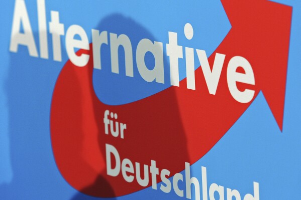 FILE -The Alternative for Germany (AfD) party logo is seen during a press conference after Germany's general election in Berlin, Monday, Sept. 23, 2013. German lawmakers have lifted the immunity from prosecution of one of the far-right Alternative for Germany party’s top candidates in the upcoming European Parliament election as he faces an investigation. (AP Photo/Jens Meyer, File)