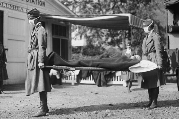 FILE - This photo made available by the Library of Congress shows a demonstration at the Red Cross Emergency Ambulance Station in Washington during the influenza pandemic of 1918. Historians think the pandemic started in Kansas in early 1918, and by winter 1919 the virus had infected a third of the global population and killed at least 50 million people, including 675,000 Americans. Some estimates put the toll as high as 100 million. (Library of Congress via AP, File)