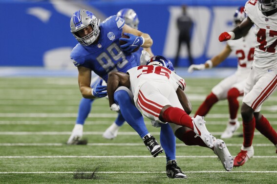 New York Giants cornerback Deonte Banks (36) tackles Detroit Lions tight end Brock Wright (89) during the first half of an NFL preseason football game, Friday, Aug. 11, 2023, in Detroit. (AP Photo/Duane Burleson)