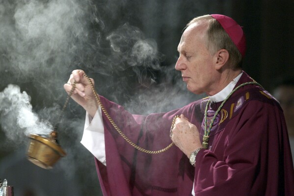 FILE — Bishop Howard Hubbard swings incense during an Ash Wednesday communion service, at the Cathedral of the Immaculate Conception, Feb. 25, 2004, in Albany, N.Y. Hubbard, a retired Catholic bishop who acknowledged covering up allegations of sexual abuse in his upstate New York diocese and recently married a woman in a civil ceremony, has died after suffering from a massive stroke, Saturday, Aug. 19, 2023. He was 84. (AP Photo/Jim McKnight, File)