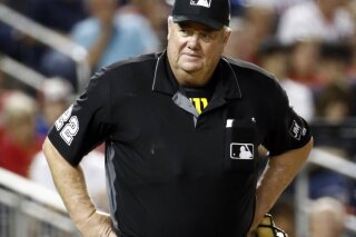 FILE - In this Sept. 27, 2019, file photo, umpire Joe West stands on the field during a baseball game between the Cleveland Indians and the Washington Nationals in Washington. Major league umpire West was awarded $500,000 in damages plus interest dating to July 8 in a defamation suit against former All-Star catcher Paul Lo Duca. (AP Photo/Patrick Semansky, File)