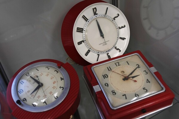 FILE - A selection of vintage clocks are displayed at the Electric Time Company, March 9, 2023, in Medfield, Mass. Next week across most of the U.S., the sun will set well before many folks step foot out of the office. Cue running errands or taking evening walks in utter darkness. Come Nov. 5, daylight saving time is out and standard time is in, and will last until March 10. (AP Photo/Charles Krupa, file)
