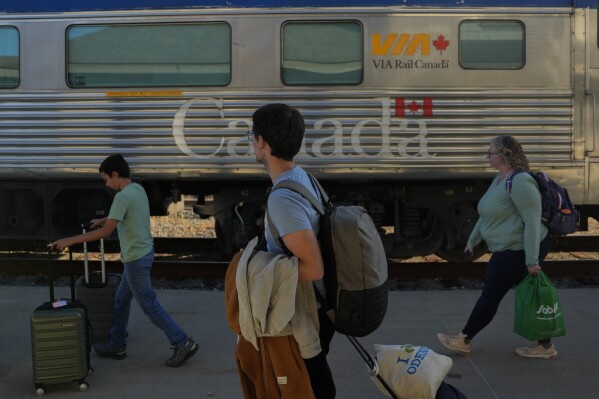Passengers prepare to board a train Thursday, Aug. 8, 2024, in Churchill, Manitoba. (AP Photo/Joshua A. Bickel)